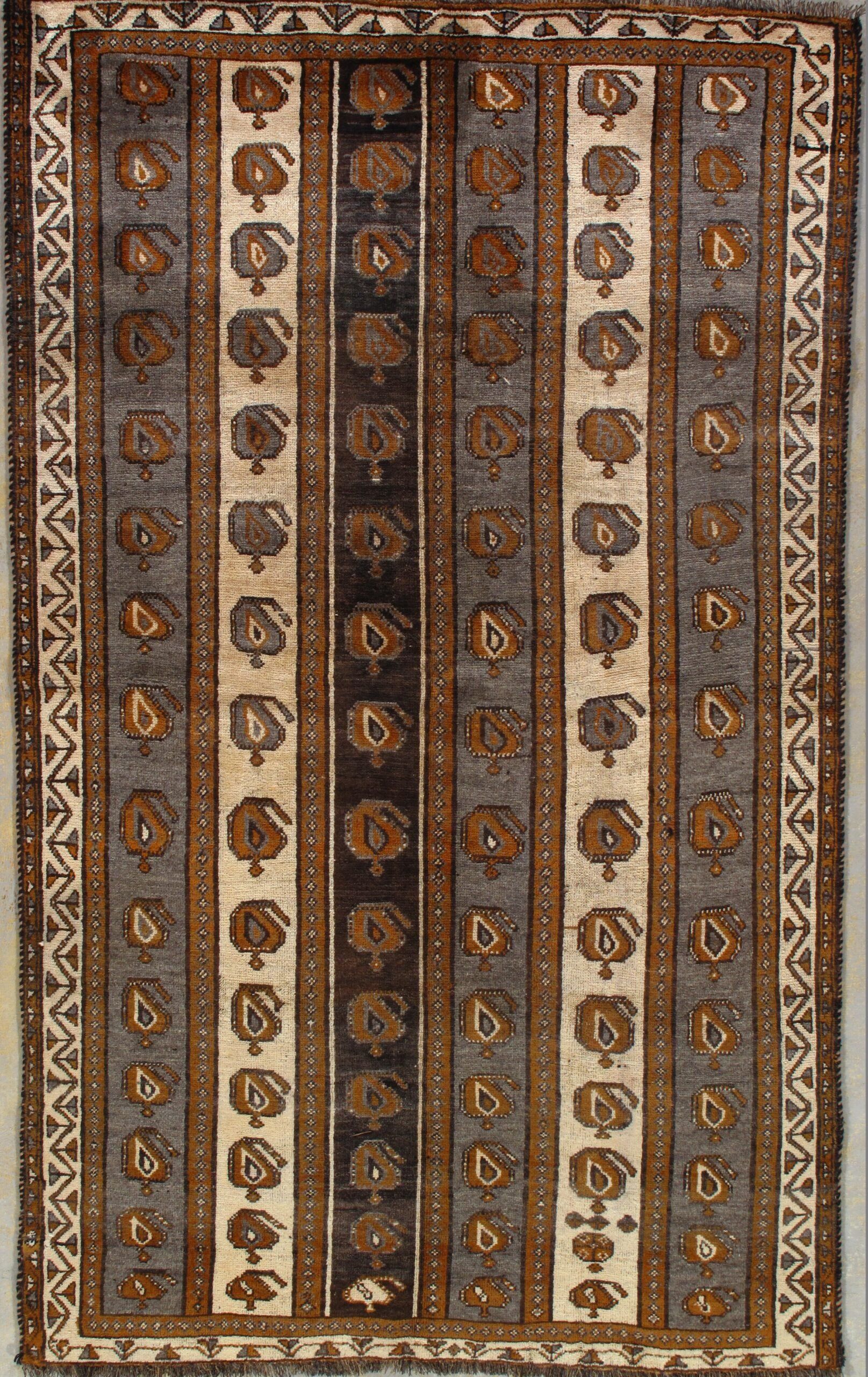 A rug with a geometric pattern on it is hanging on a wall.