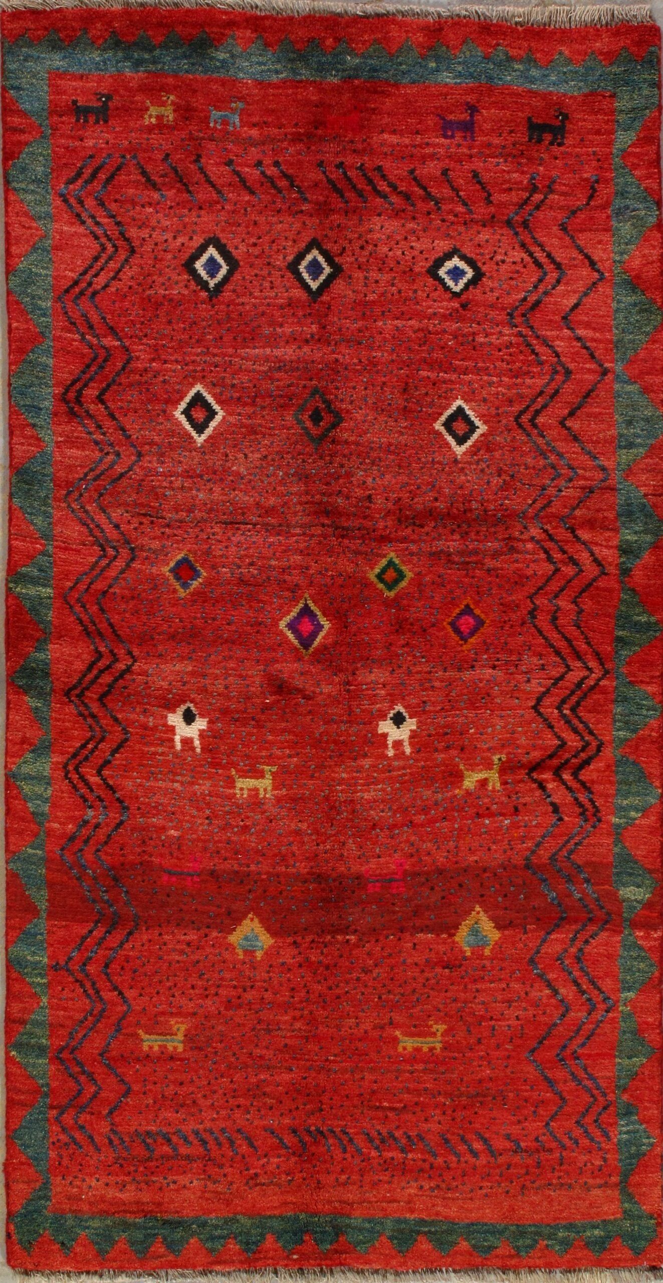 A red rug with a pattern on it is sitting on a table.