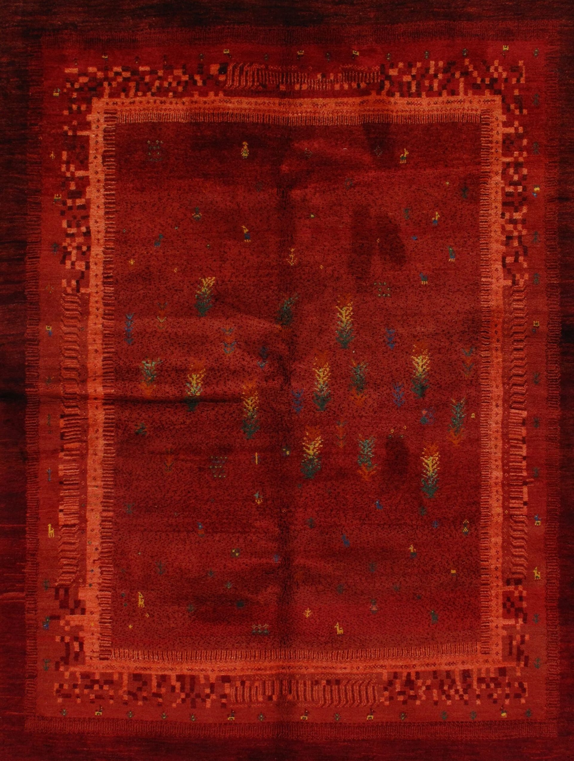 A close up of a red rug with a square pattern on it.