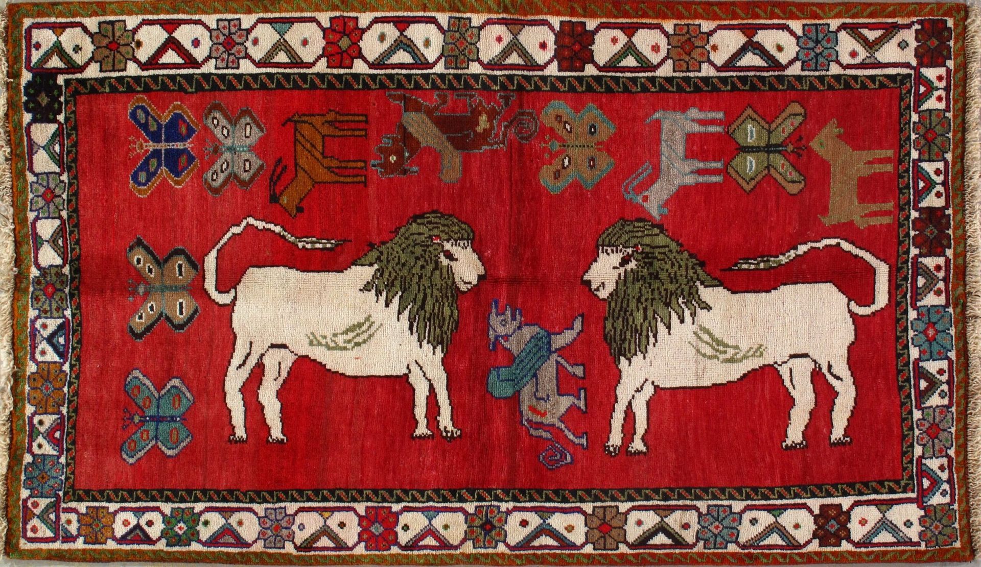 A red rug with two lions on it