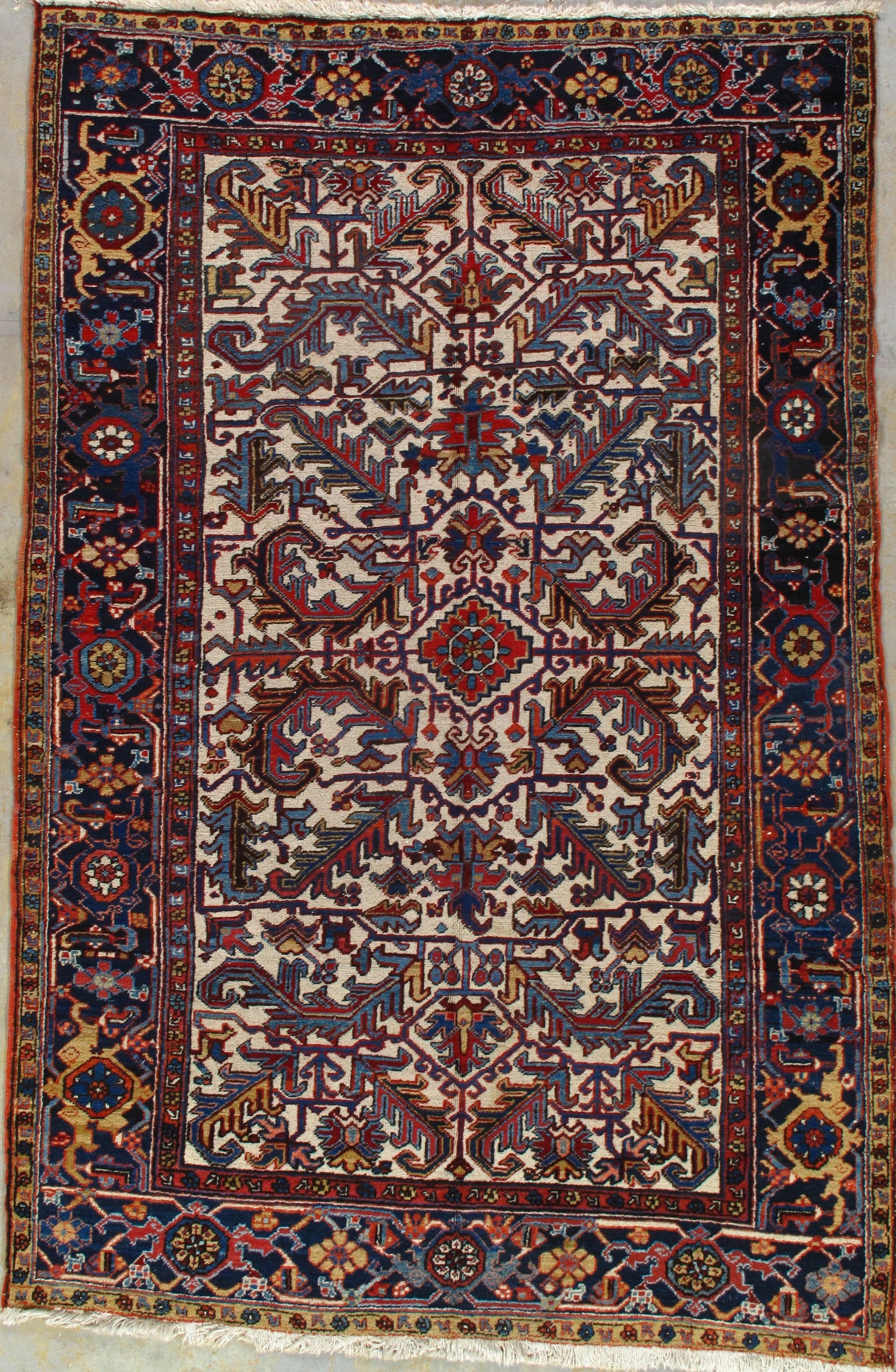 A rug with a floral pattern on it is hanging on a wall.