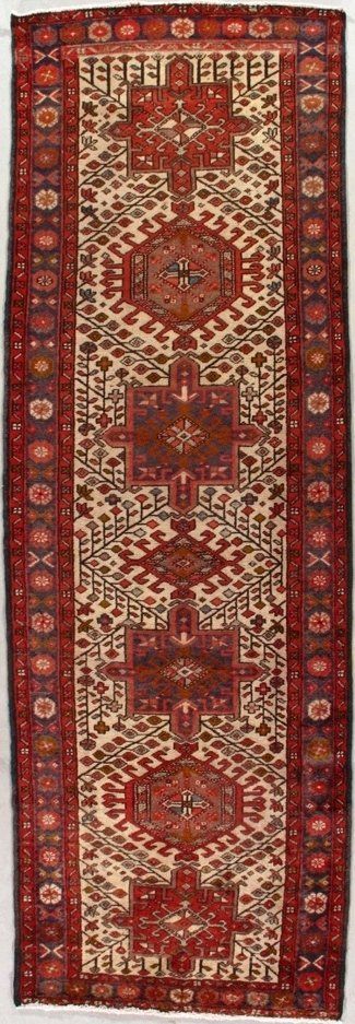 A red and white rug with a pattern on it is on a white surface.