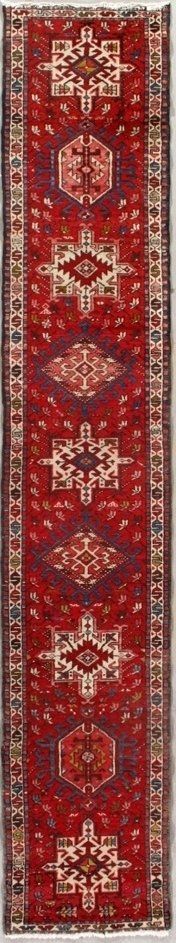 A red rug with a pattern on it is on a white background.