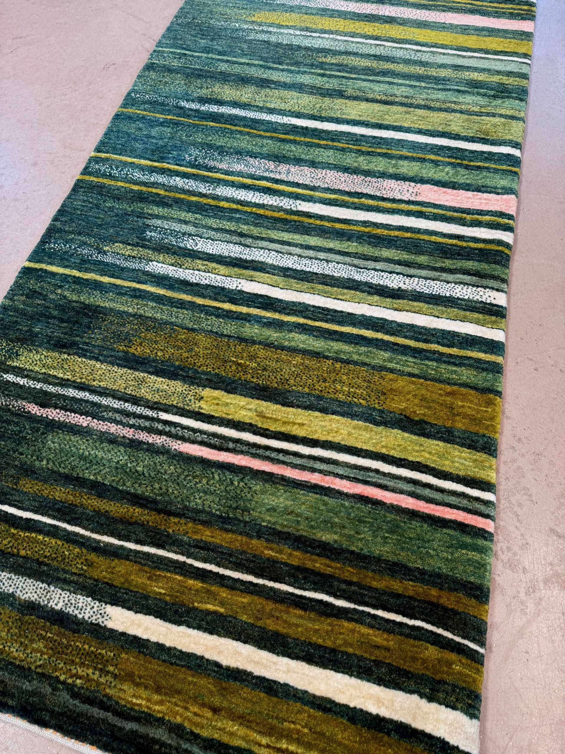 A rug with a striped pattern on it is on a white background.