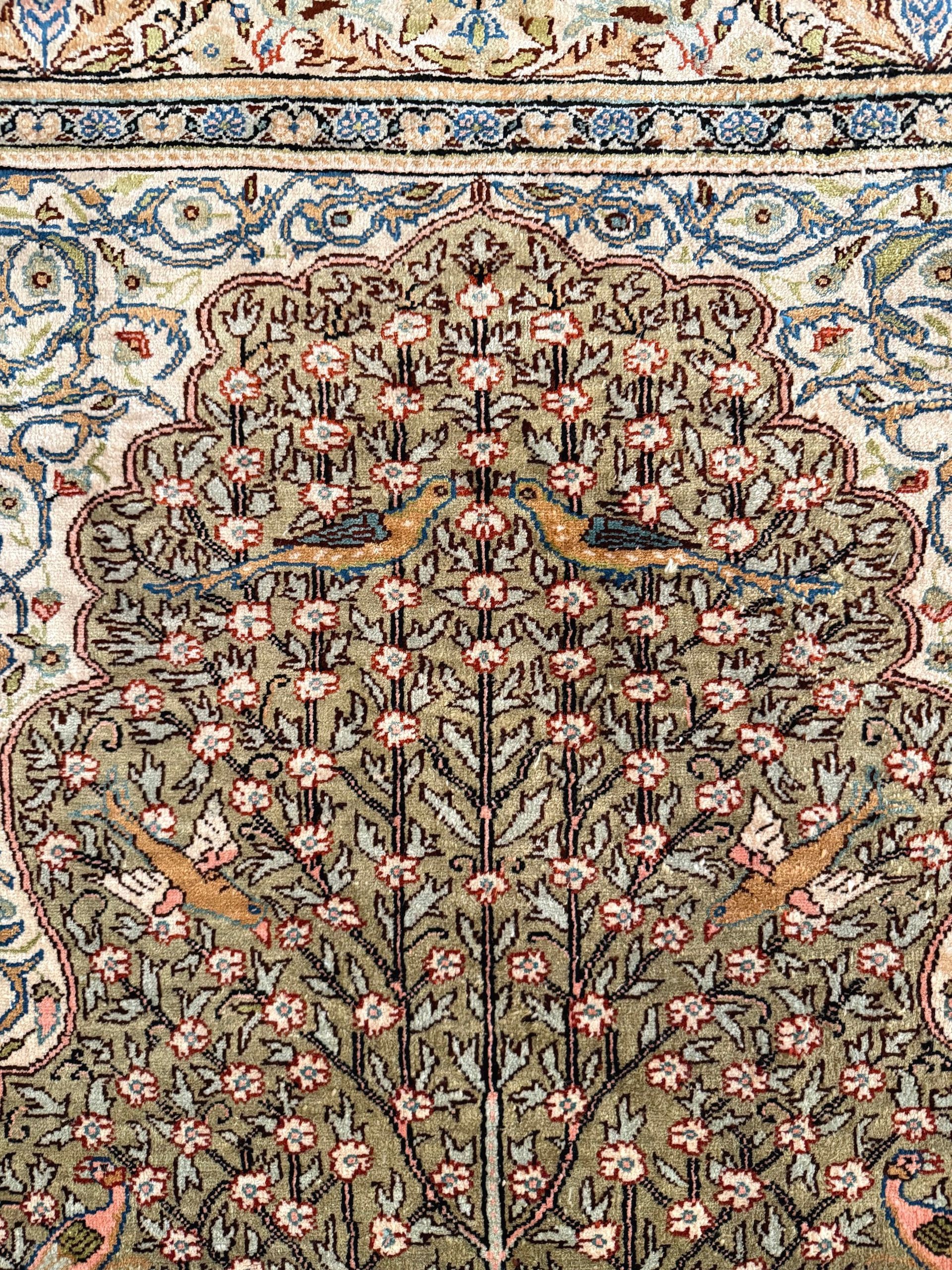 A rug with a tree on it on a white background.