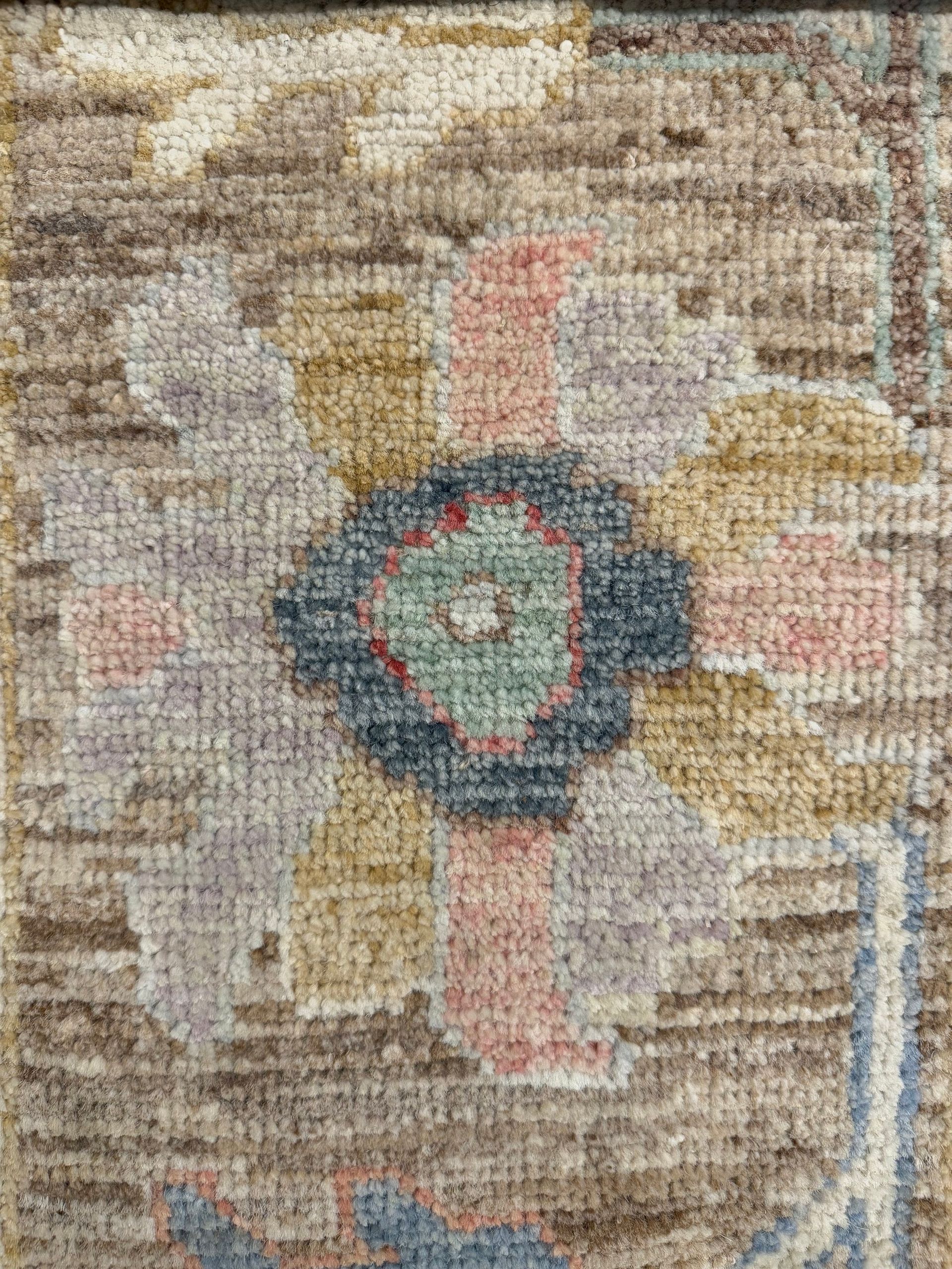 A rug with a floral pattern on it is on a white background