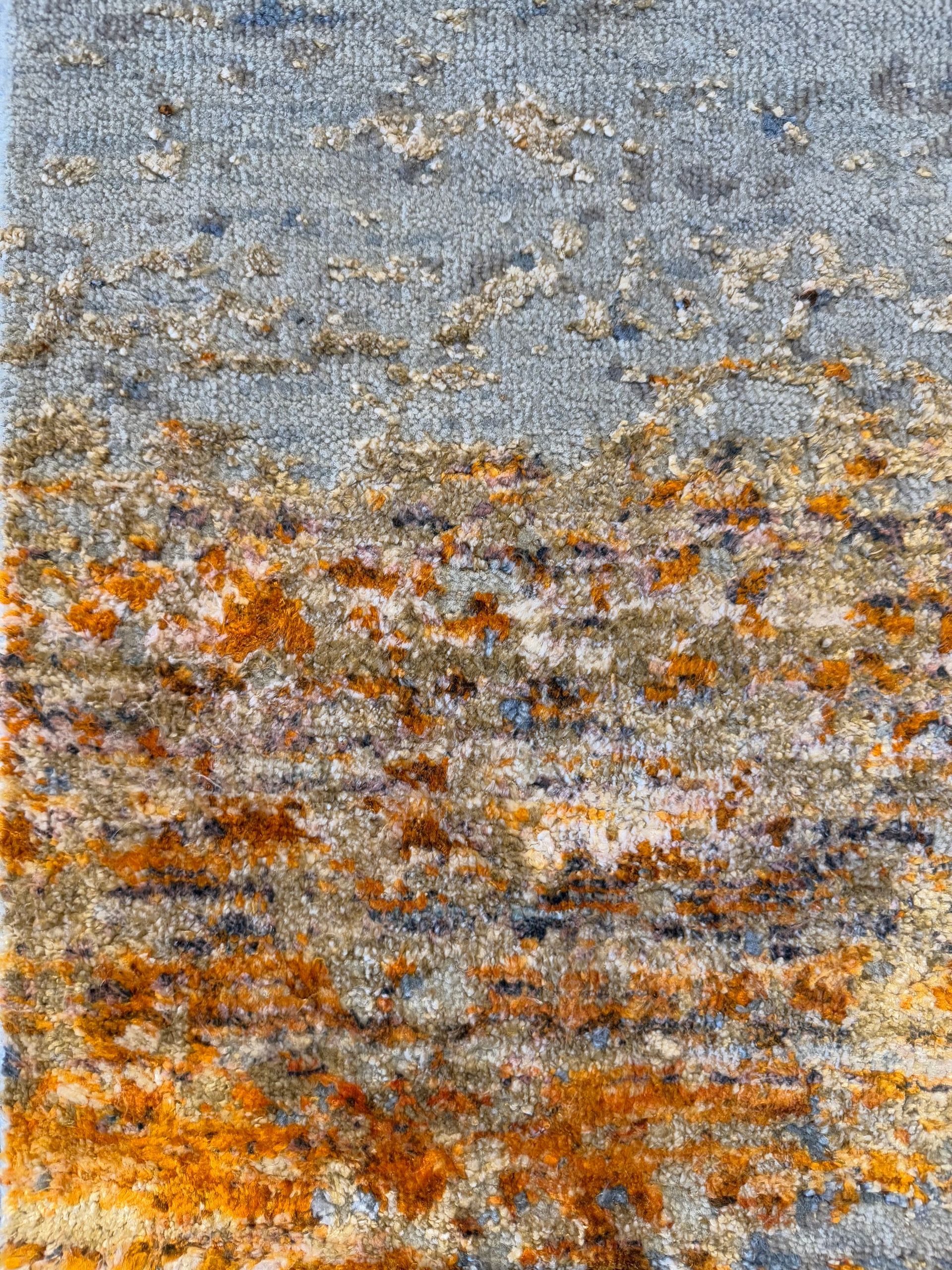 A rug with a blue and orange pattern on a white background.