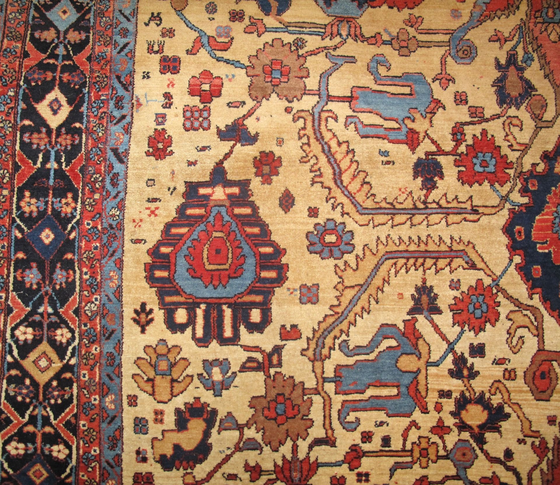 A rug with a floral pattern on it is hanging on a wall.