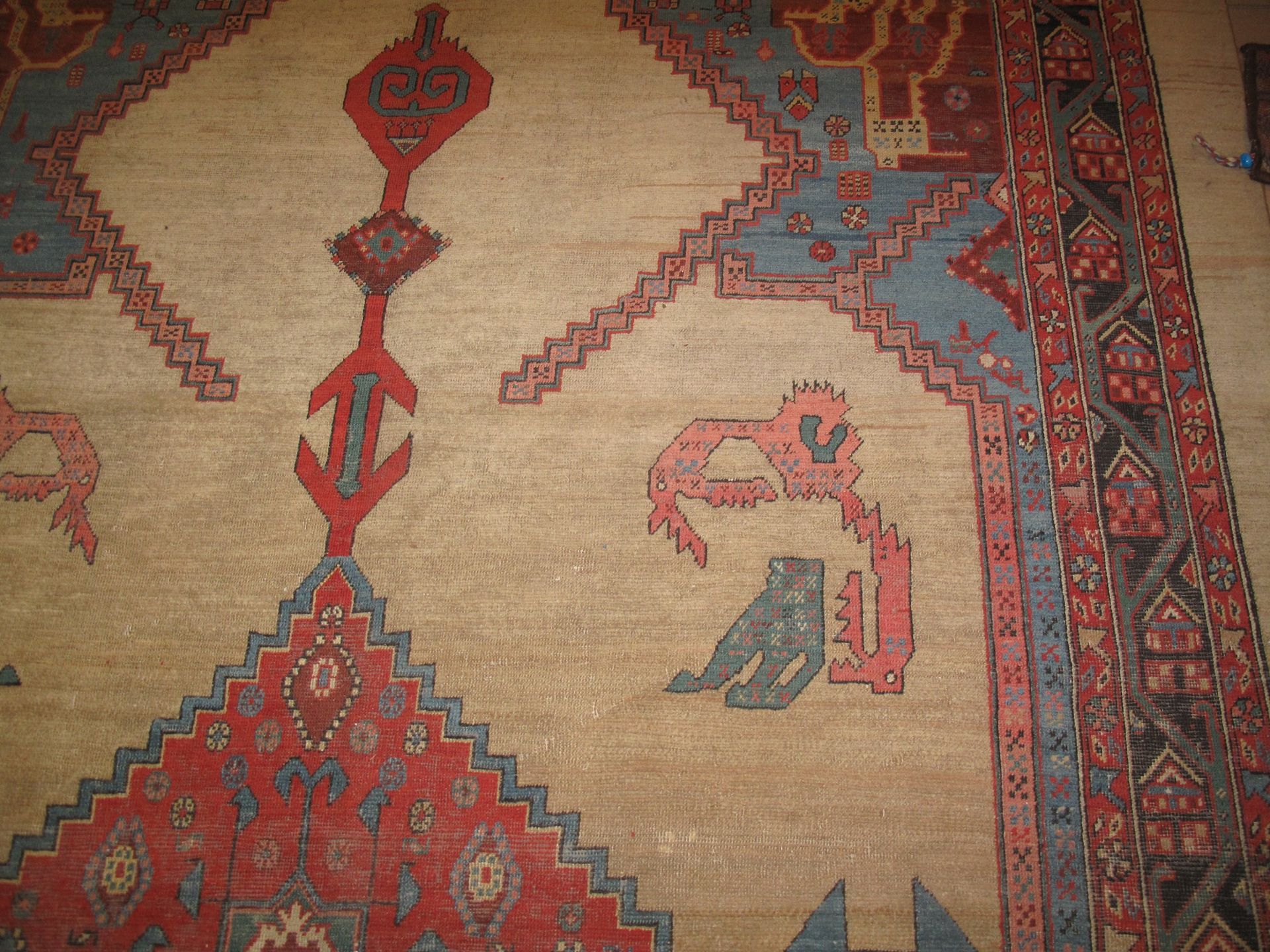 A rug with a geometric pattern and animals on it