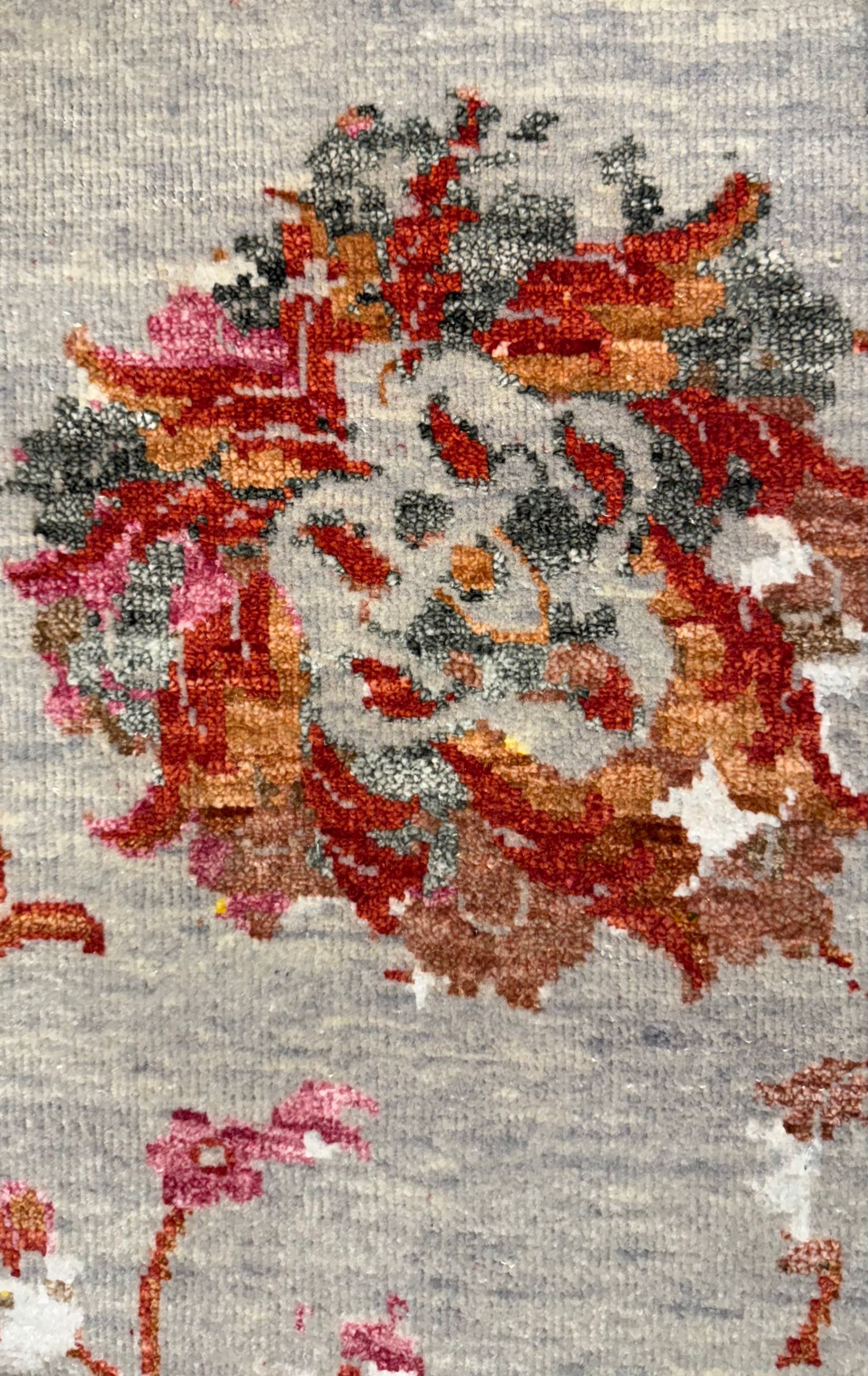 A rug with a floral pattern on it is on a white background.