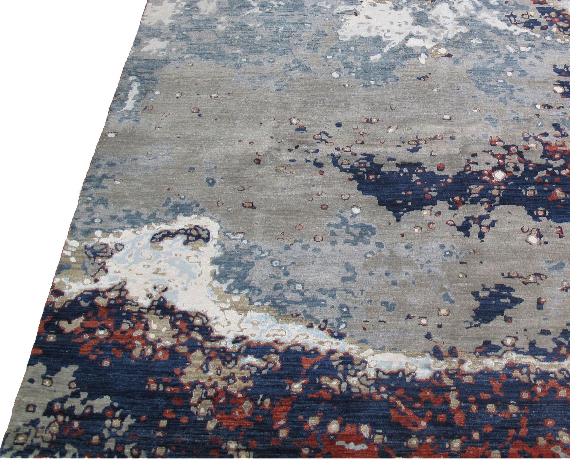 A rug with a colorful pattern on it is sitting on a white surface.