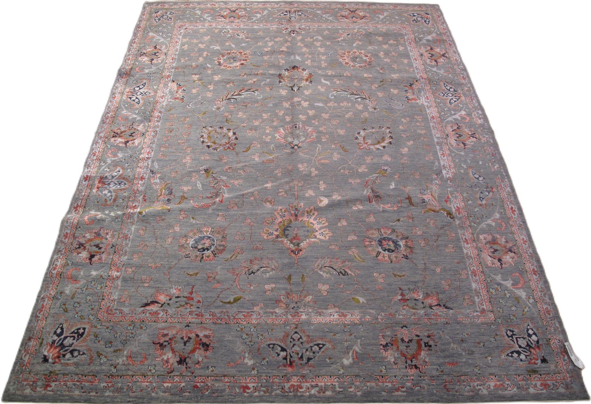 A rug with a floral pattern on it is on a white background.