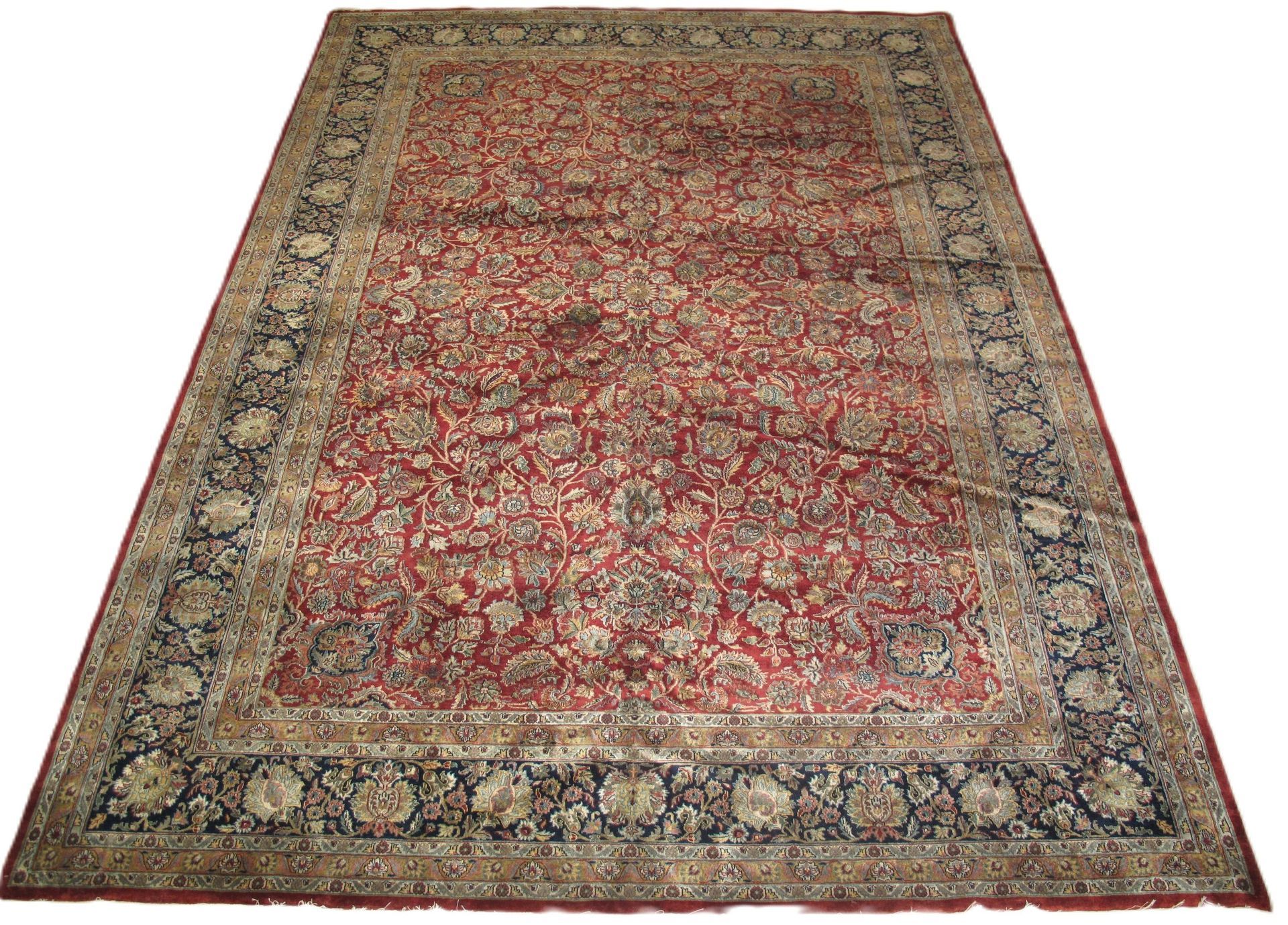 A red rug with a floral pattern on it is on a white background.