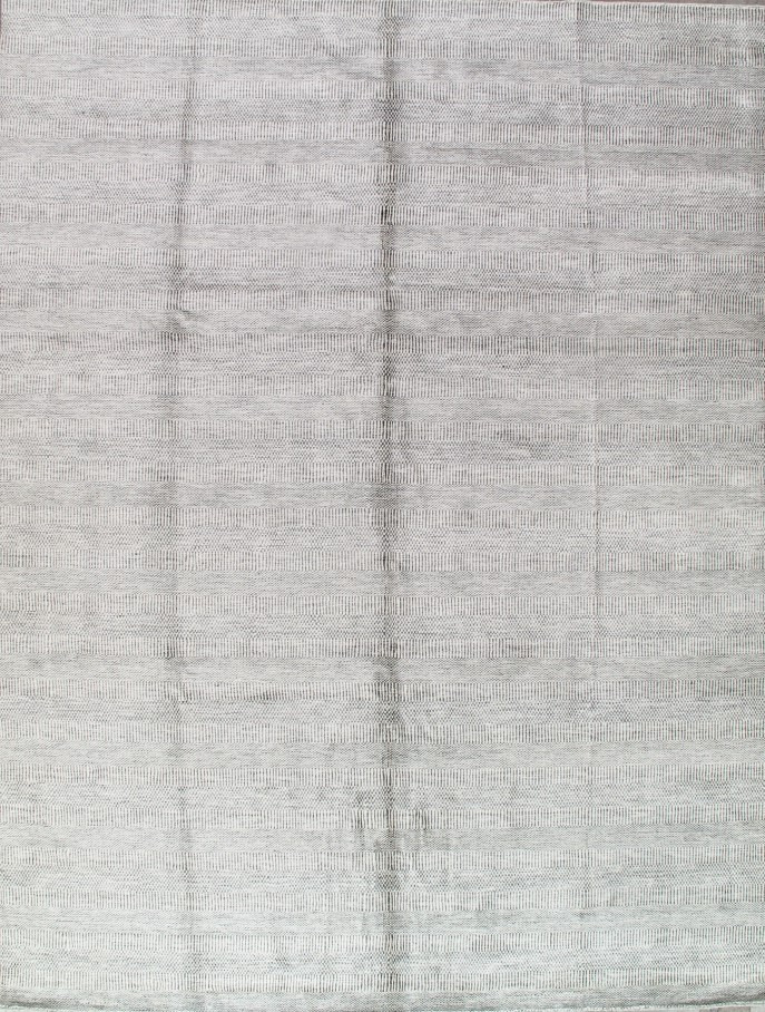 A close up of a white rug with a pattern on it.