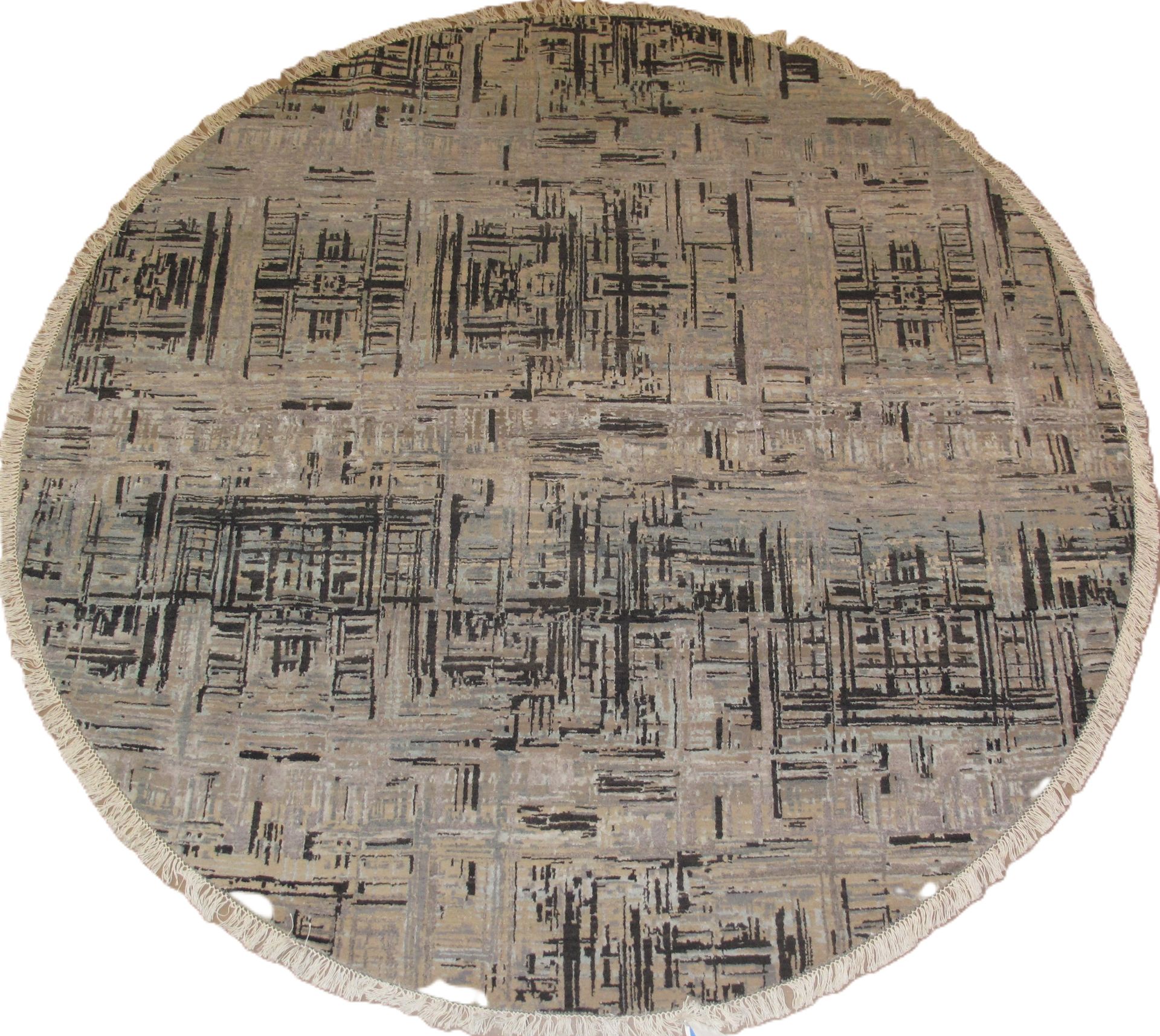 Round rug with gray and black geometric pattern, fringed edge.