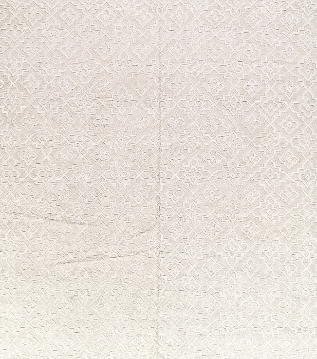 A close up of a white cloth with a pattern on it.