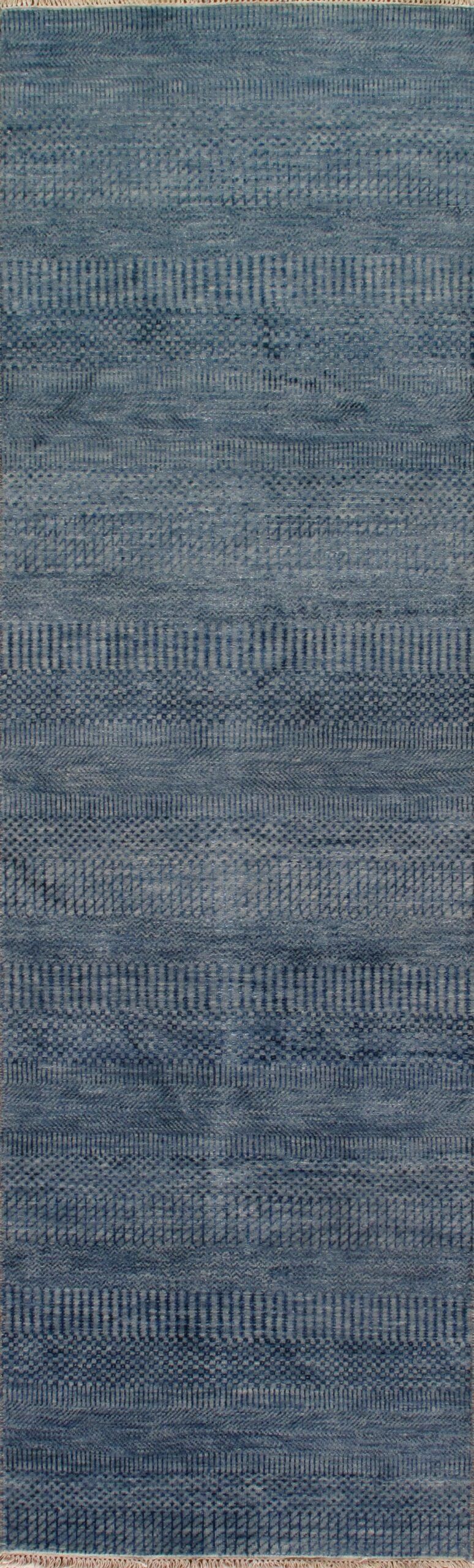 A close up of a blue rug with a pattern on it.