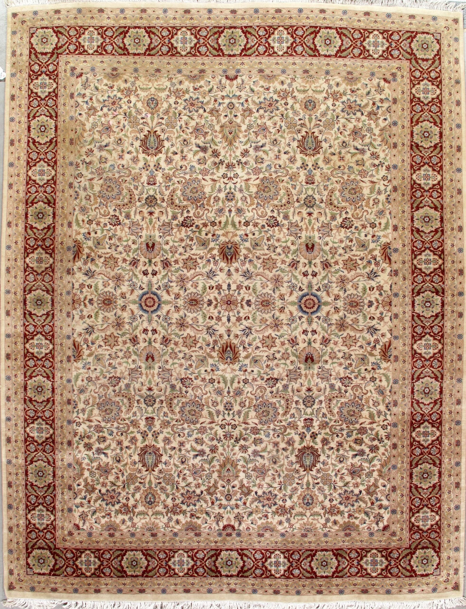 A rug with a floral pattern and a red border is sitting on a table.