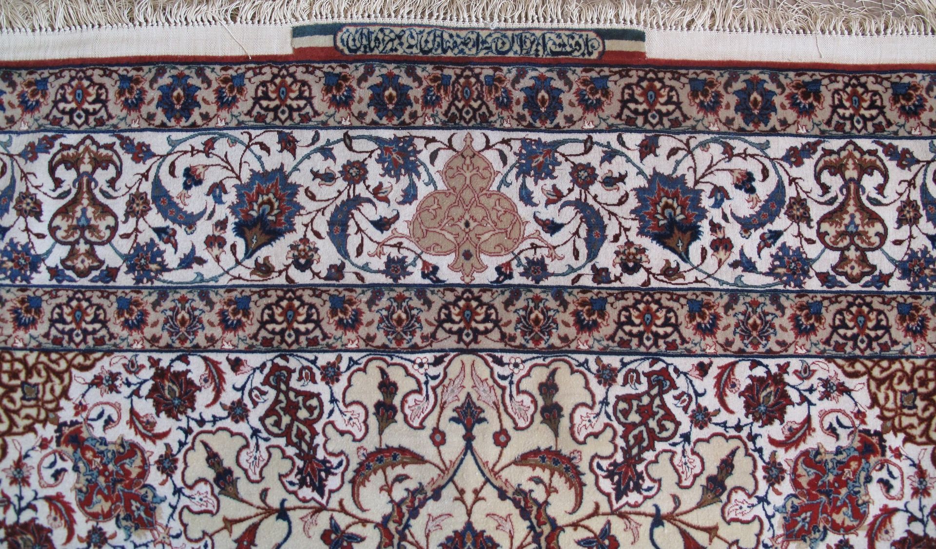 A rug with a floral pattern on it is sitting on a white surface.