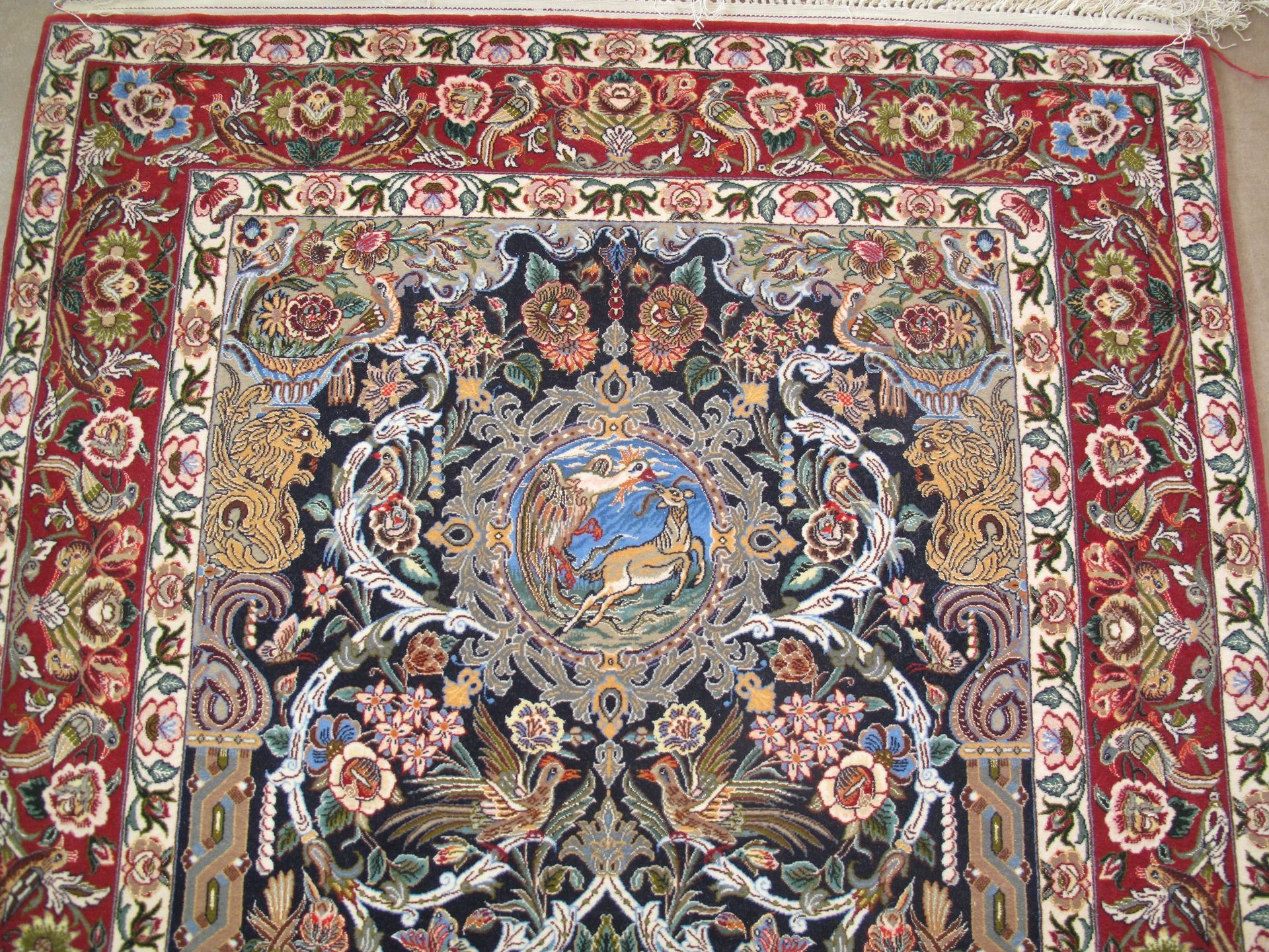 A rug with a floral pattern on it is on a white background.