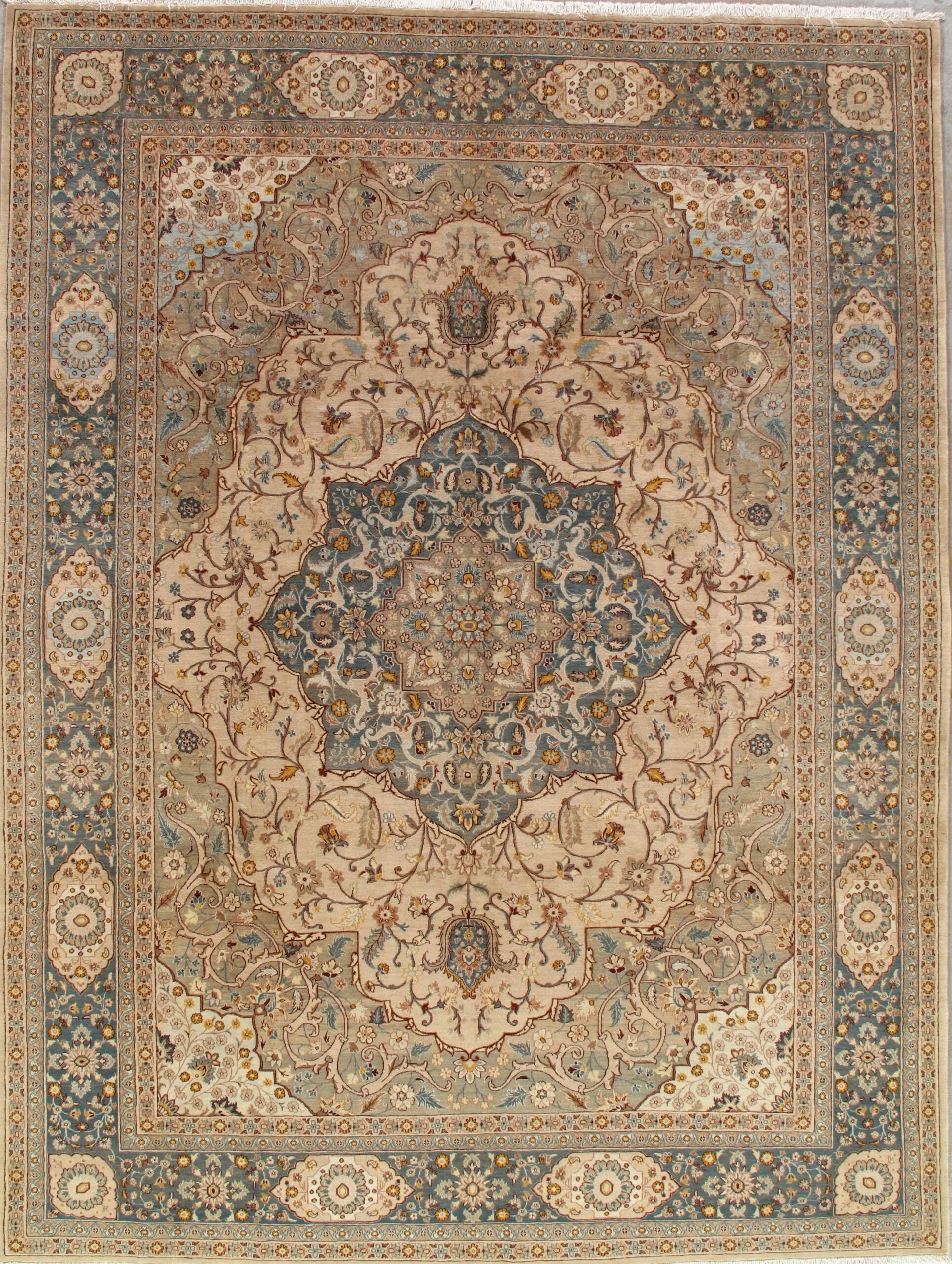 A rug with a floral pattern on it is hanging on a wall.