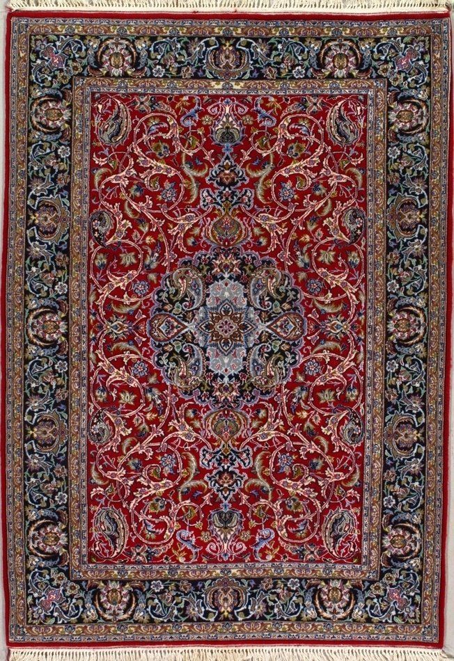 A red rug with a floral pattern on it is hanging on a wall.