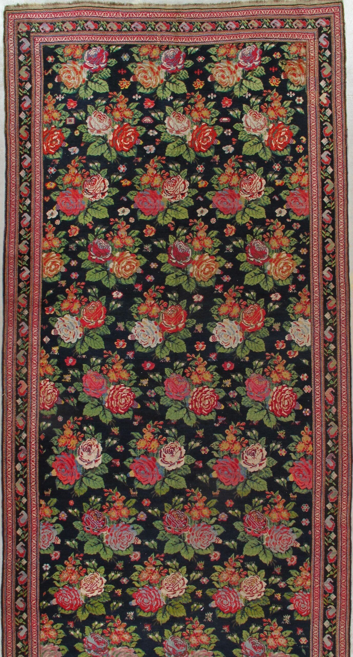 A rug with a floral pattern on it is sitting on a table.