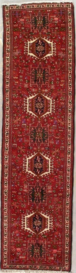 A red rug with a pattern on it is sitting on a table.
