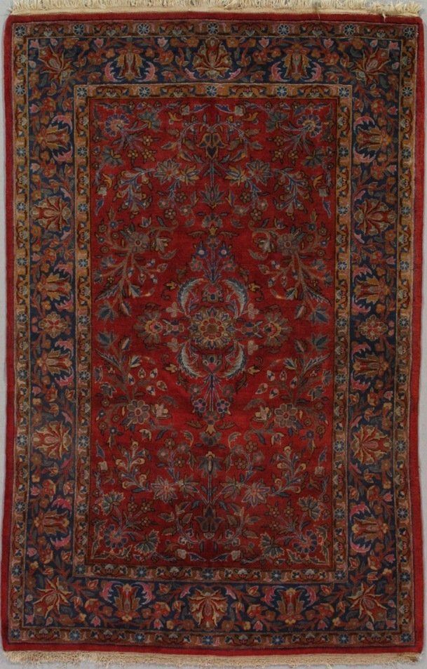 A red rug with a floral pattern on it is sitting on a table.