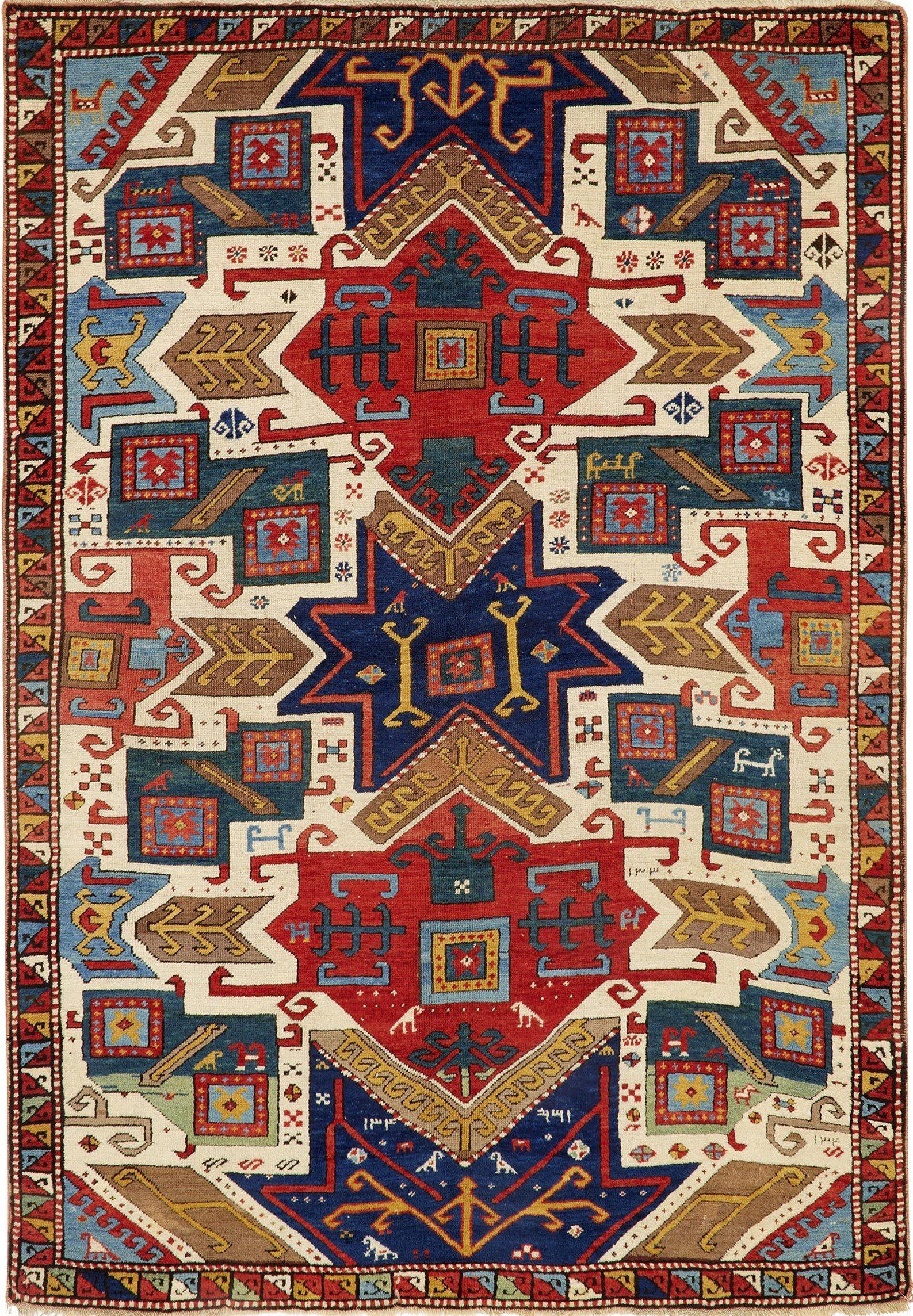 A colorful rug with a geometric pattern on it is on a white background.