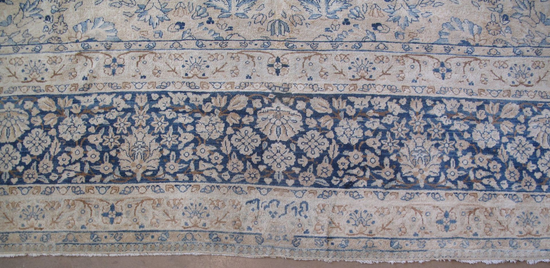 A rug with a black border is on a white background