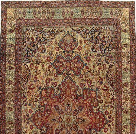 A close up of a rug with a floral pattern on it.