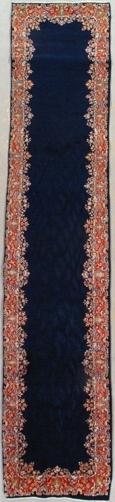 A blue rug with a red and white border