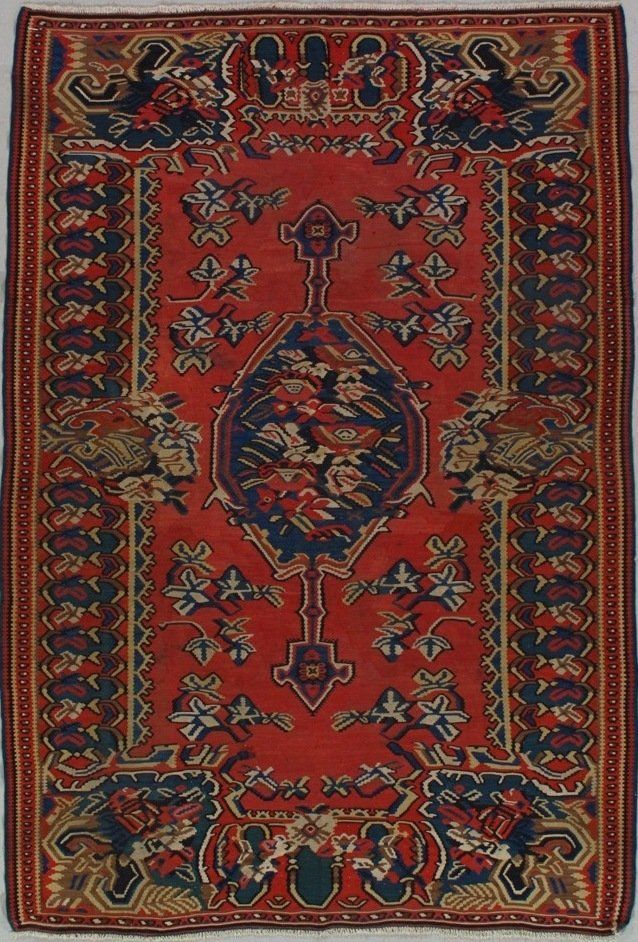 A red rug with a floral pattern on it