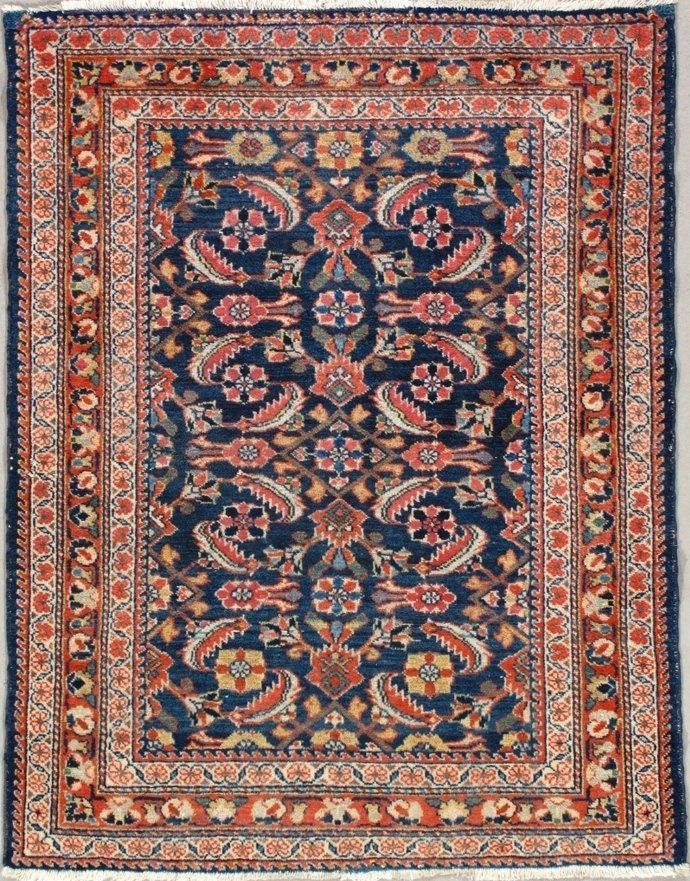 A blue and red rug with a floral pattern on it