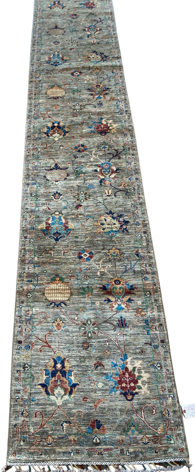 A long rug with a pattern on it is sitting on a table.