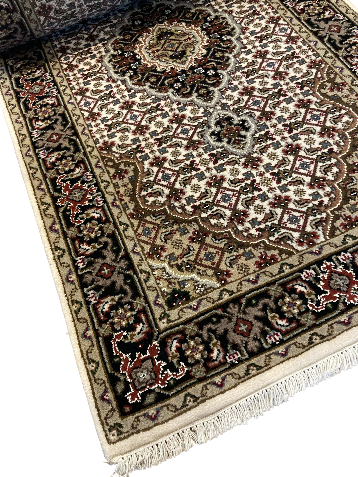 A close up of a rug on a white background.