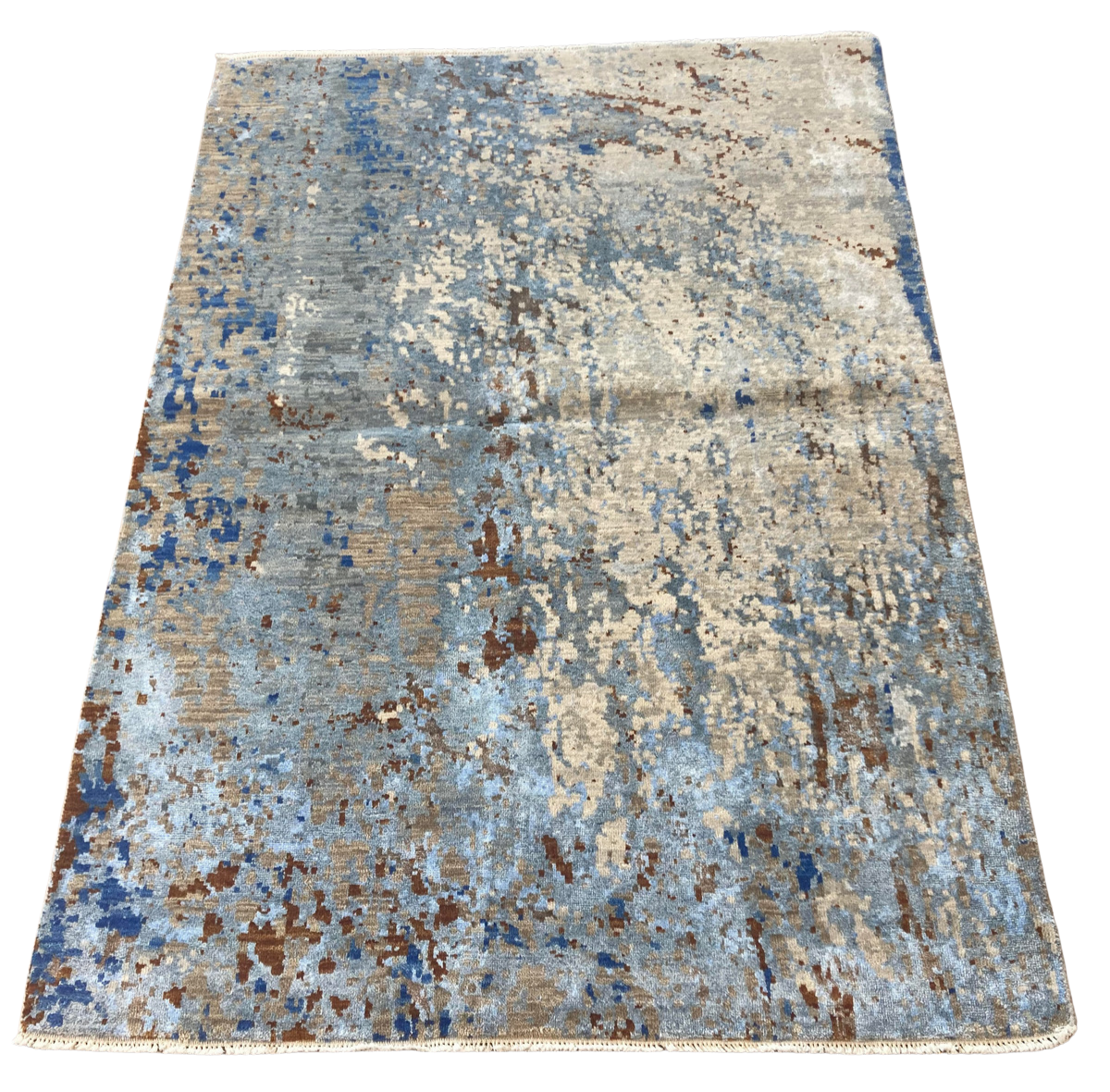 A rug with a blue and brown pattern on a white background.
