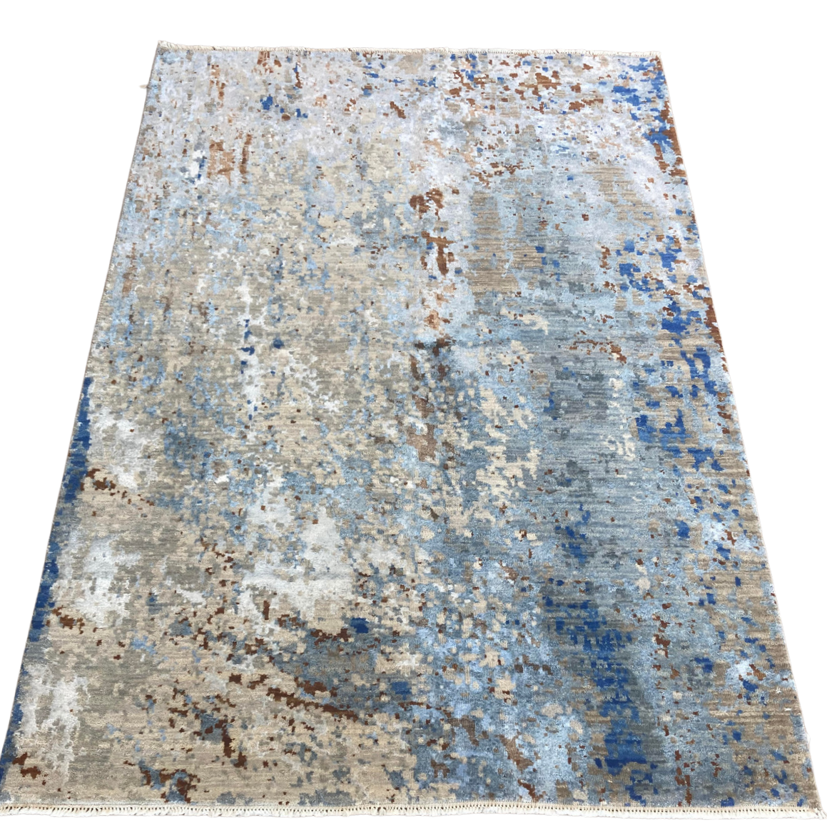 A rug with a blue and brown pattern on a white background.