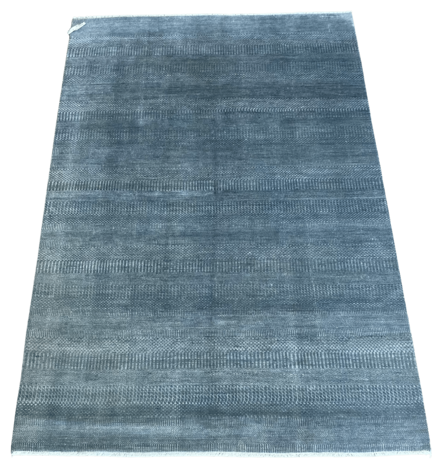 A blue rug with a pattern on it is on a white background.