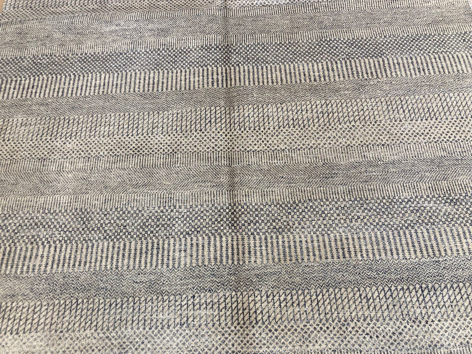 A rug with a pattern on it is on a white background.