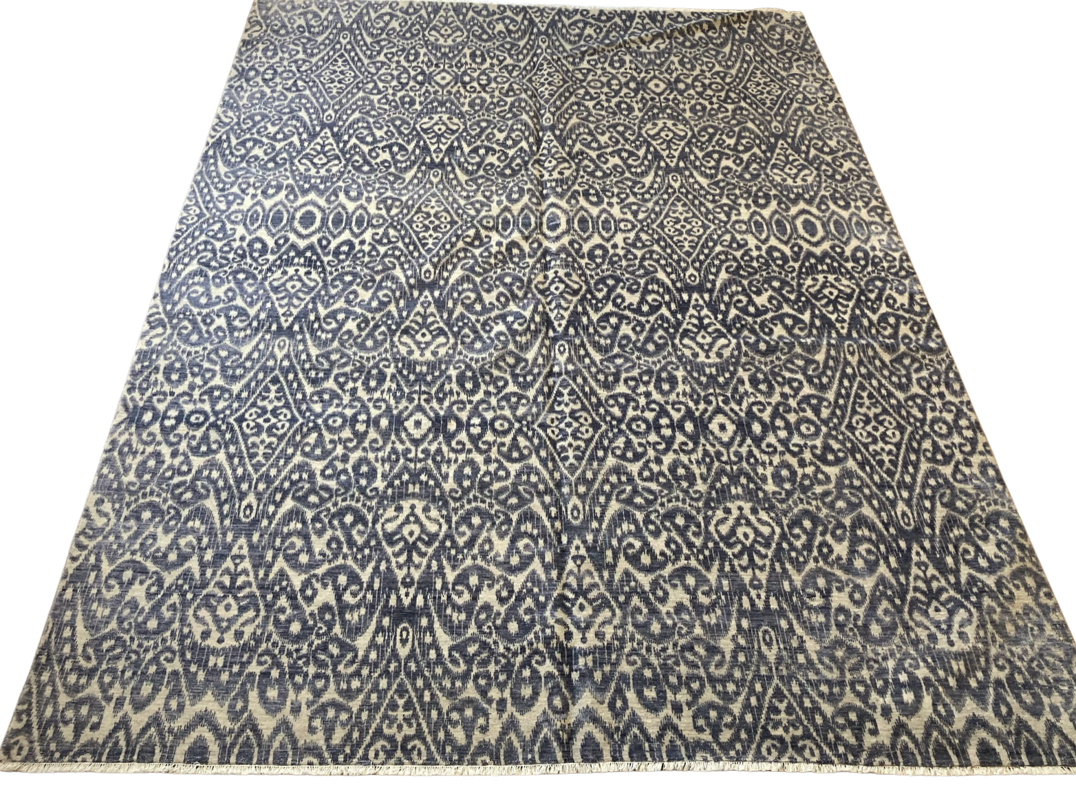 A rug with a pattern on it is on a white background.