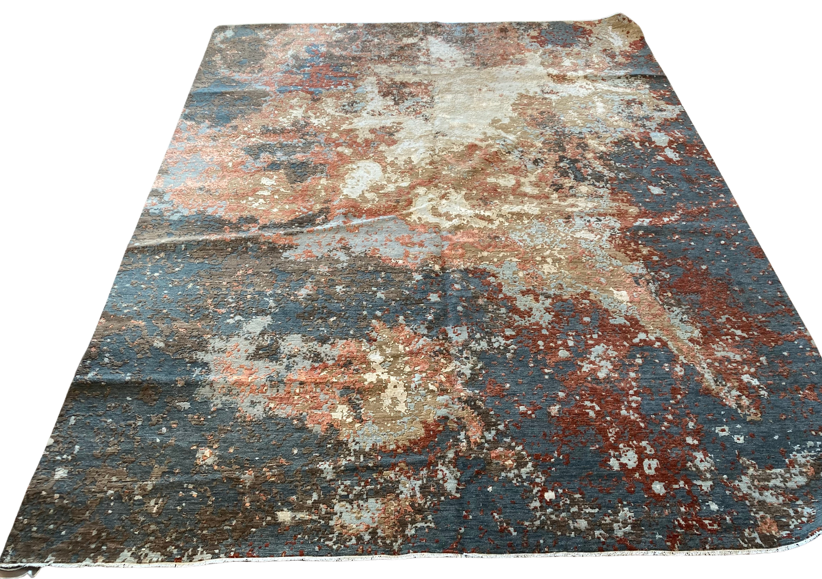 A rug with a painting on it is on a white background.