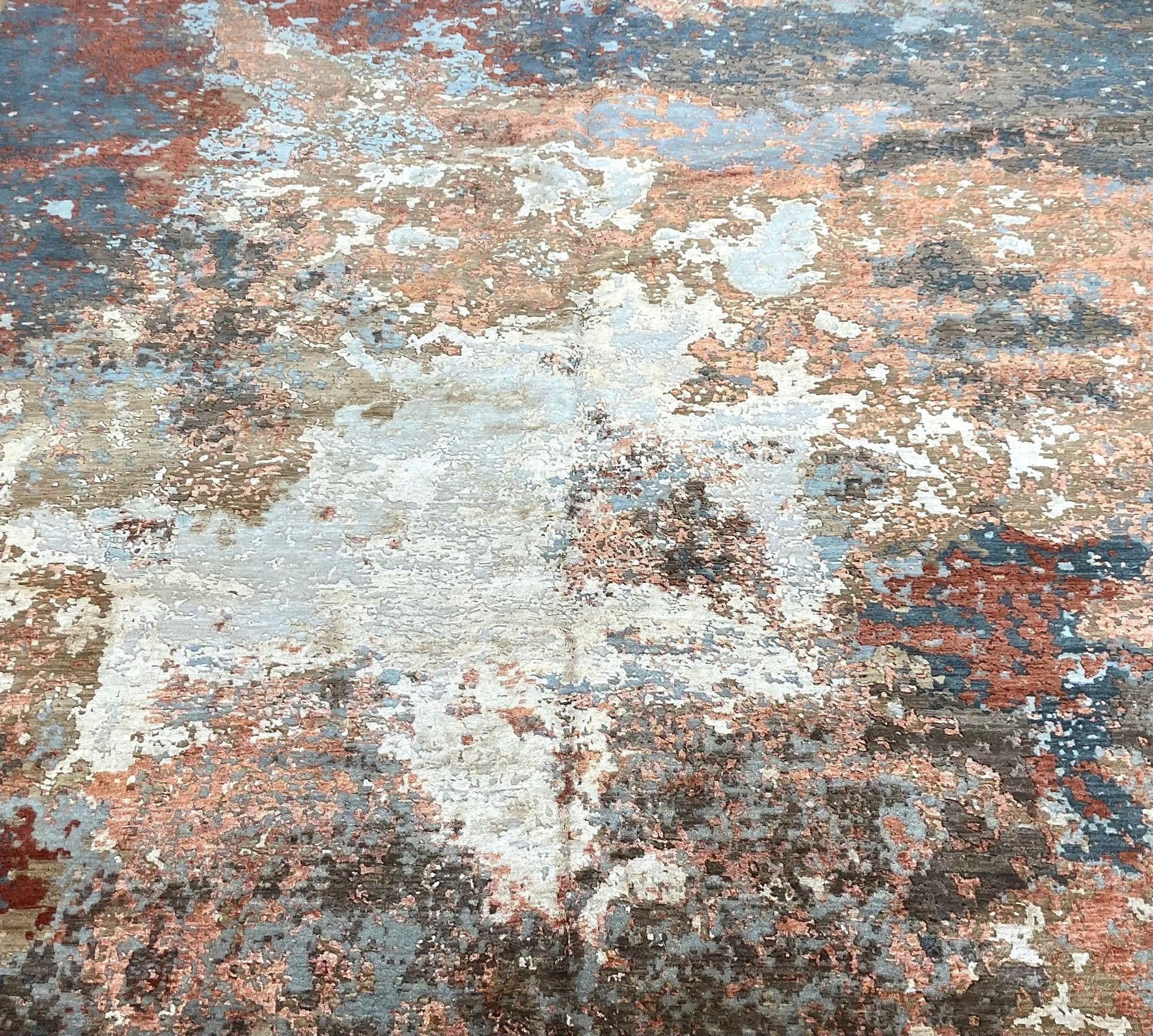 A close up of a rug with a painting on it.