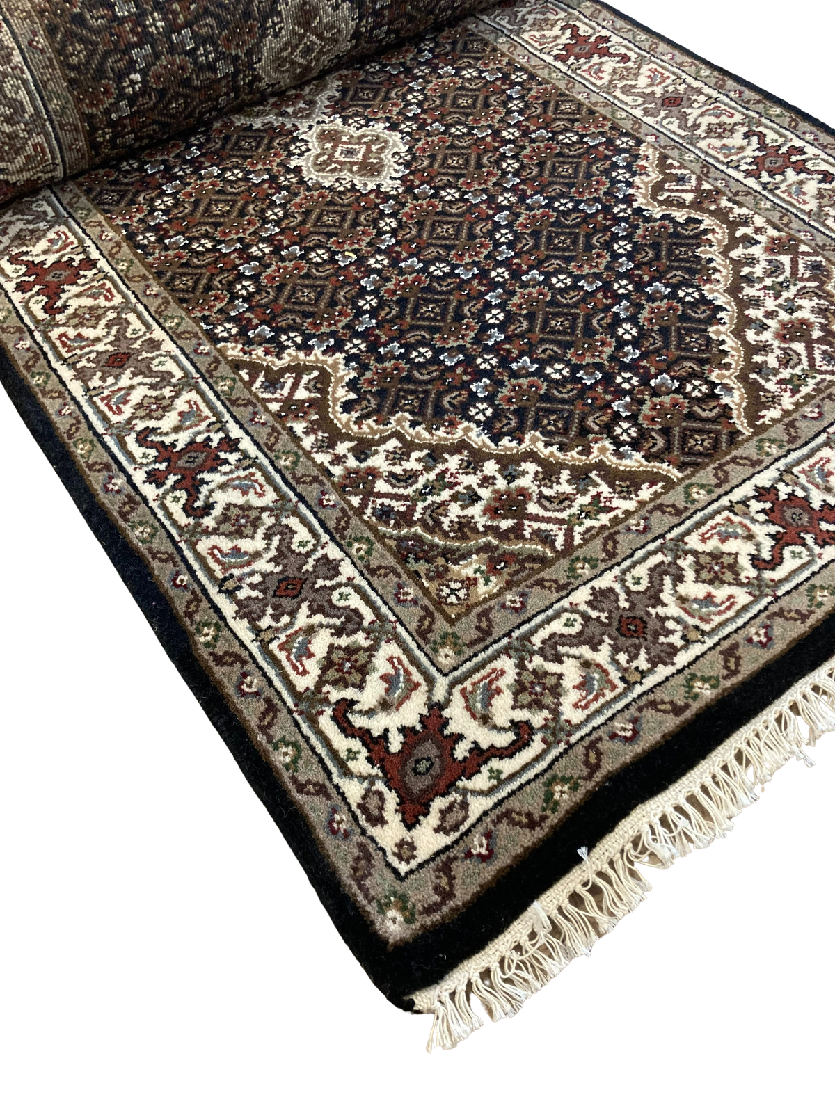 A close up of a rug on a white background.