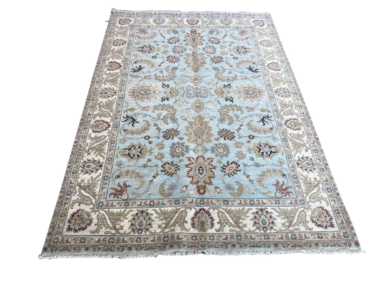 A light blue rug with a floral pattern on a white background.