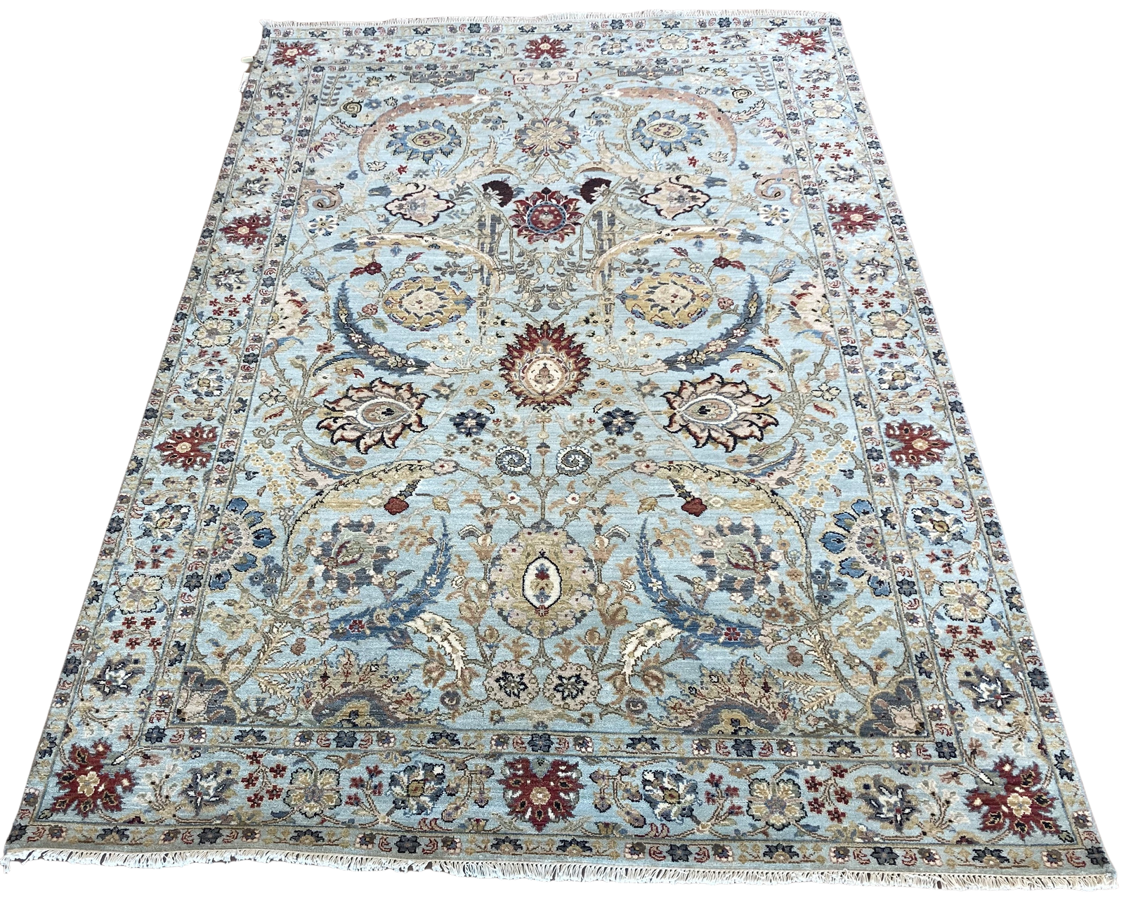 A rug with a floral pattern on it is on a white background.