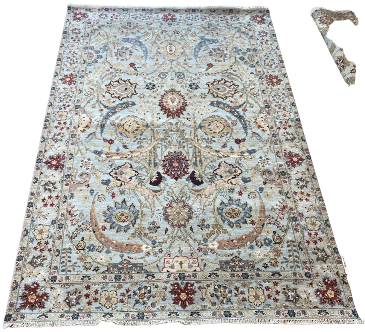 A rug with a floral pattern on it is on a white background.
