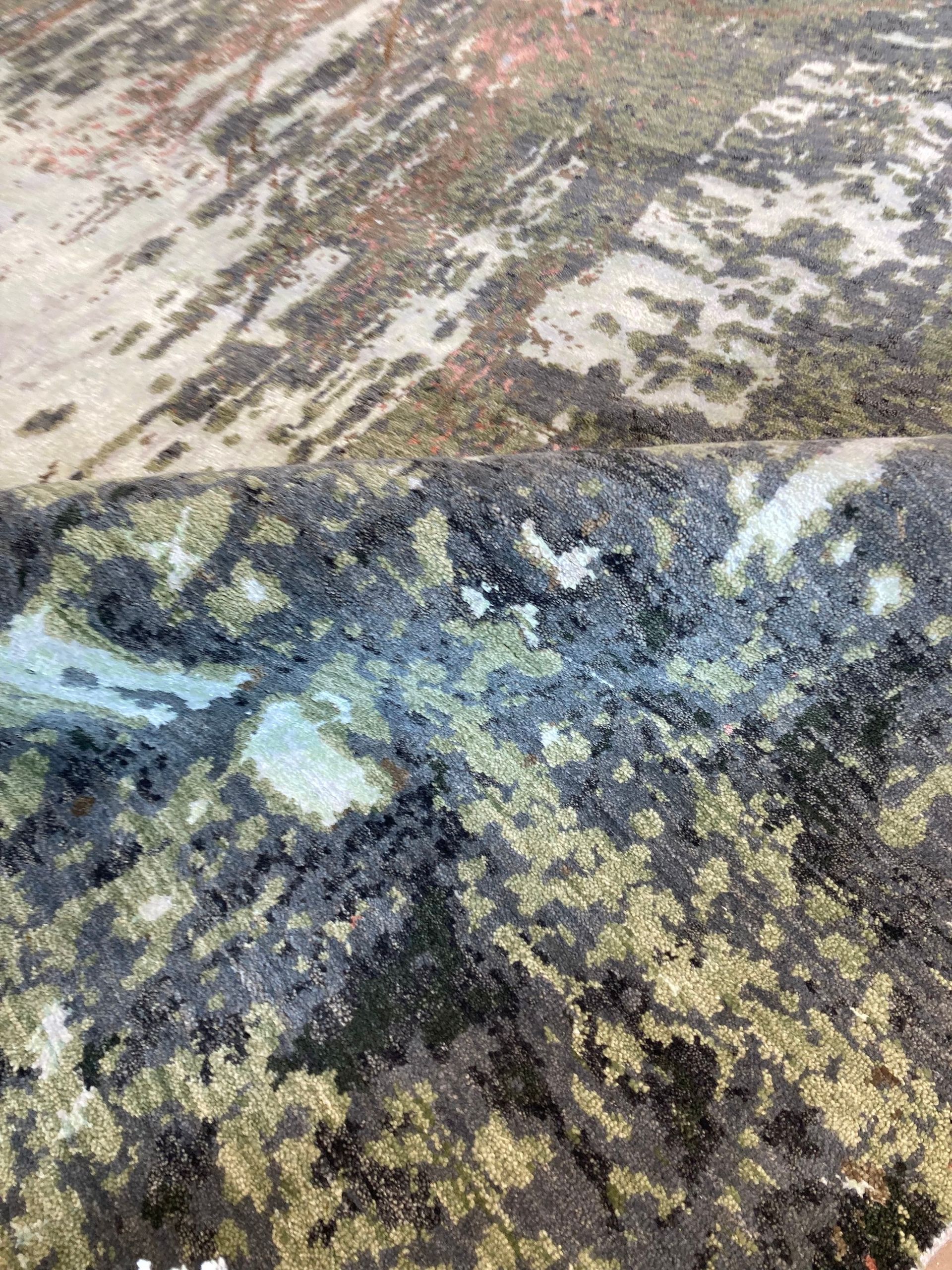 A rug with a painting on it is on a white background.