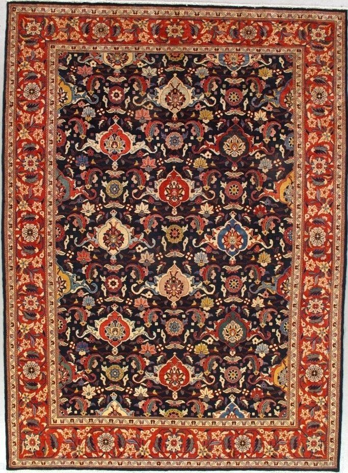 A rug with a floral pattern on it is hanging on a wall.